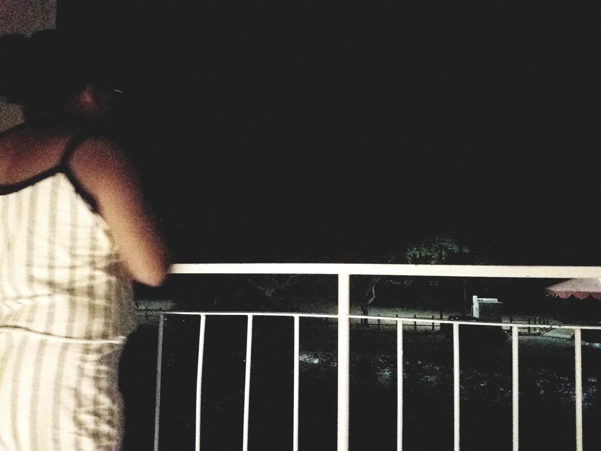 On a balcony at night